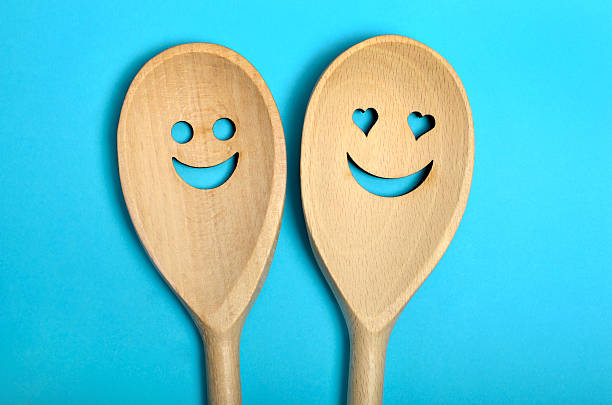 Two lovely wooden spoon on blue background