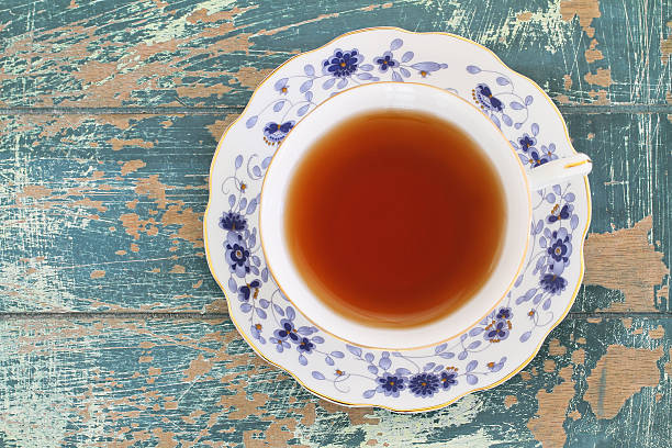 istock Black tea in vintage cup on rustic wood, copy space 494568836