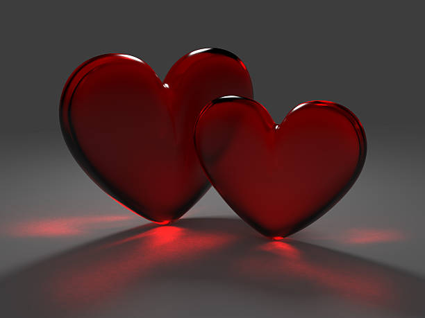 istock Two red hearts from frosted glass with caustic effect 494571676