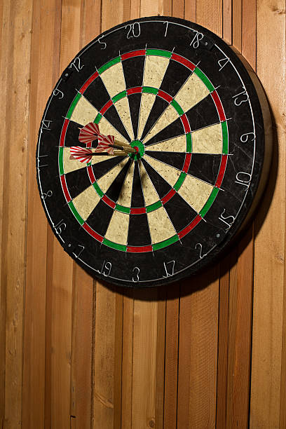 istock The darts isolated on wooden background 494585322