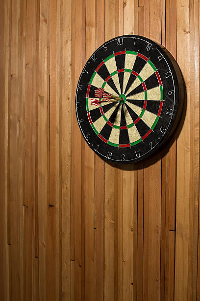 istock The darts isolated on wooden background 494585392