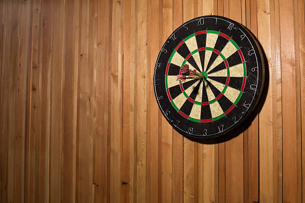 istock The darts isolated on wooden background 494585488