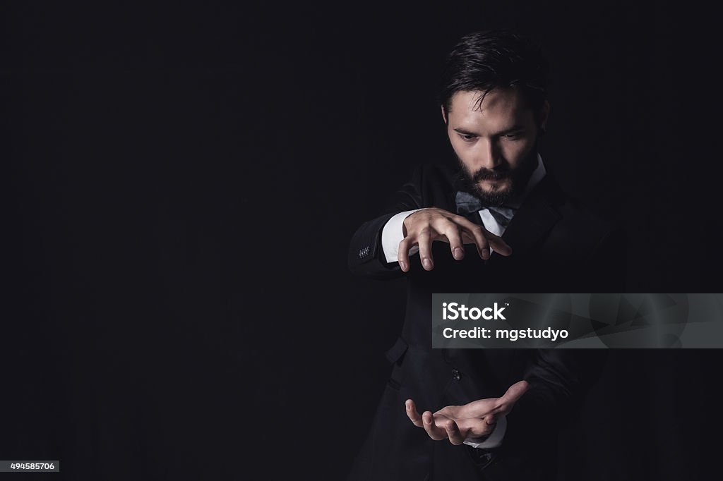 handsome business man handsome businessman suit and black background Magician Stock Photo