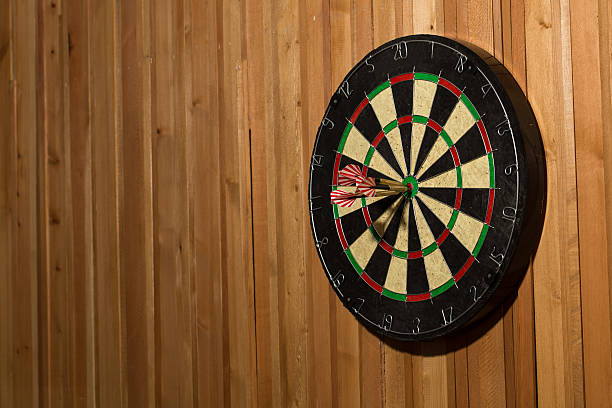 istock The darts isolated on wooden background 494585738