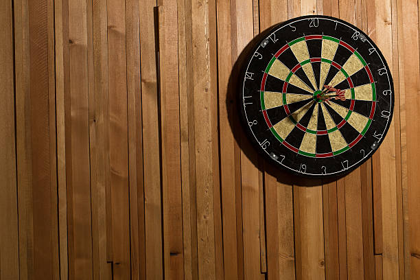 istock The darts isolated on wooden background 494585814