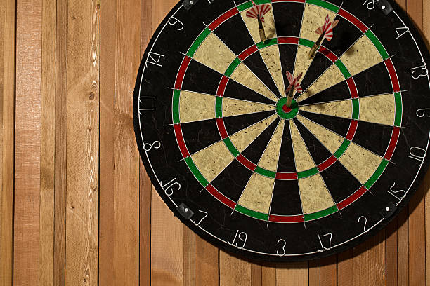 istock The darts isolated on wooden background 494586140