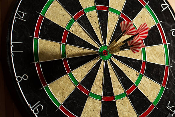 istock The darts isolated on wooden background 494586202