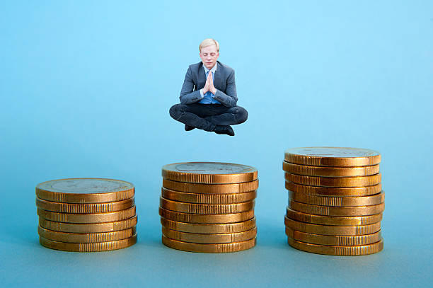 istock Businessman meditating on the money 494586226