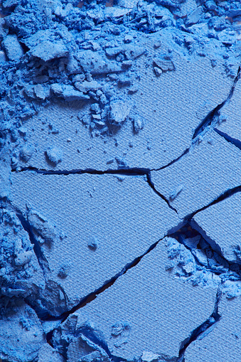 Blue eye shadow crushed cosmetic texture background