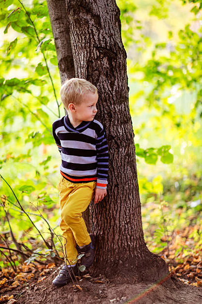 istock autumn baby boy stands near a tree, looking back  forest 494587504