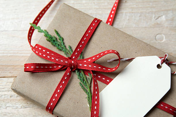 istock Gift box, wrapped in recycled paper, red bow 494590522