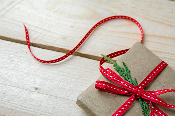 istock Gift box, wrapped in recycled paper and red bow 494590666