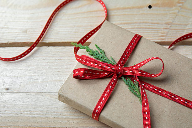 istock Gift box, wrapped in recycled paper and red bow 494590806
