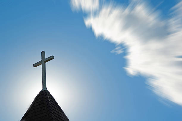 istock Church steeple with cross at sunset  Copy space and zoom 494590826