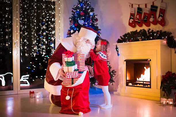 istock Kids and Santa opening Christmas presents 494591184