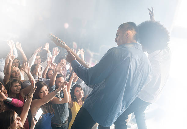 Guitarist on stage for background, vibrant soft and motion blur concept