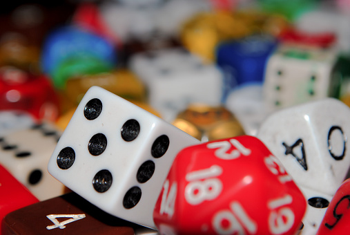 A beautiful closeup of dice. D6 D20 and others in a pile