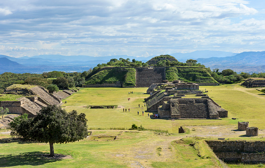 Monte Alban, Mexico - October 15, 2015: Tourists visit Monte Alban archaeological site located near Oaxaca city, Mexico. This was the capital of Zapotec between 500 BC - 700 AD.