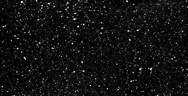 Falling snow on black background stock photo