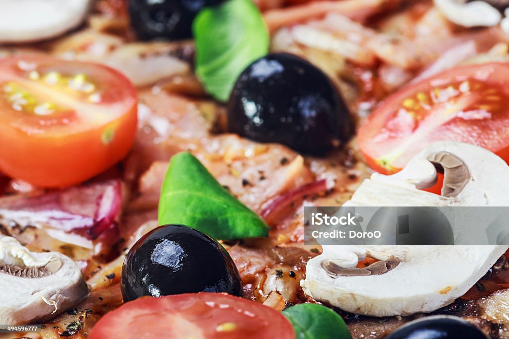 filling pizza with olives and tomatoes filling pizza with olives and tomatoes. Focus on the olive Baked Stock Photo