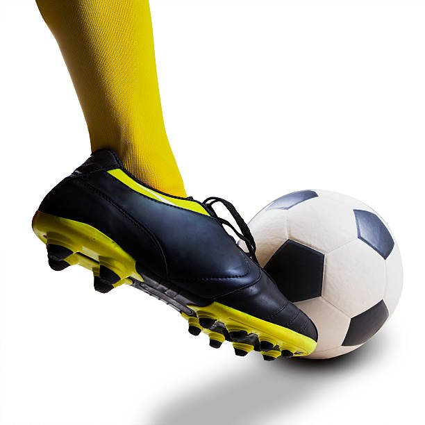 istock Foot kicking soccer ball isolated 494596935