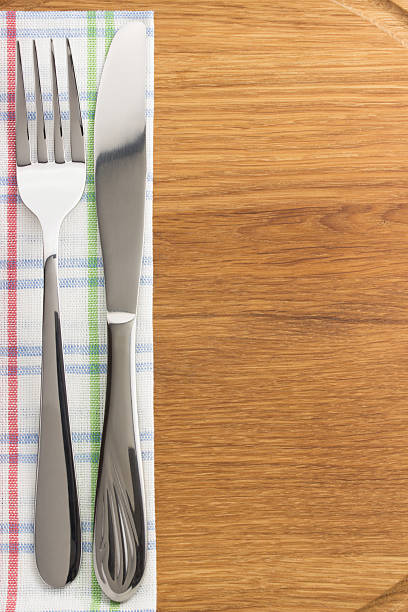 istock knife and fork at napkin on wood 494596979