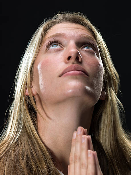 blonde young woman praying
