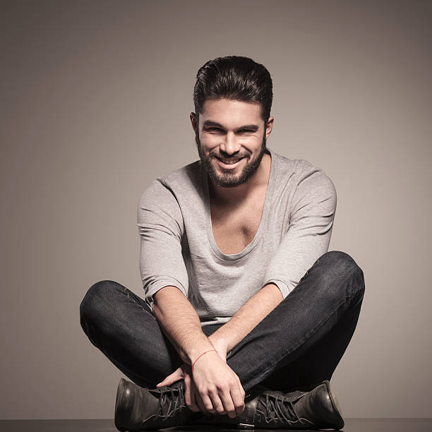 istock happy young man sits in yoga position 494597391