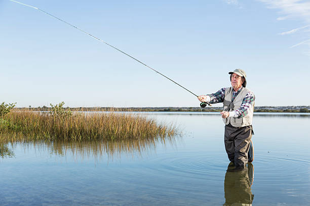 istock Senior man fly fishing 494597479