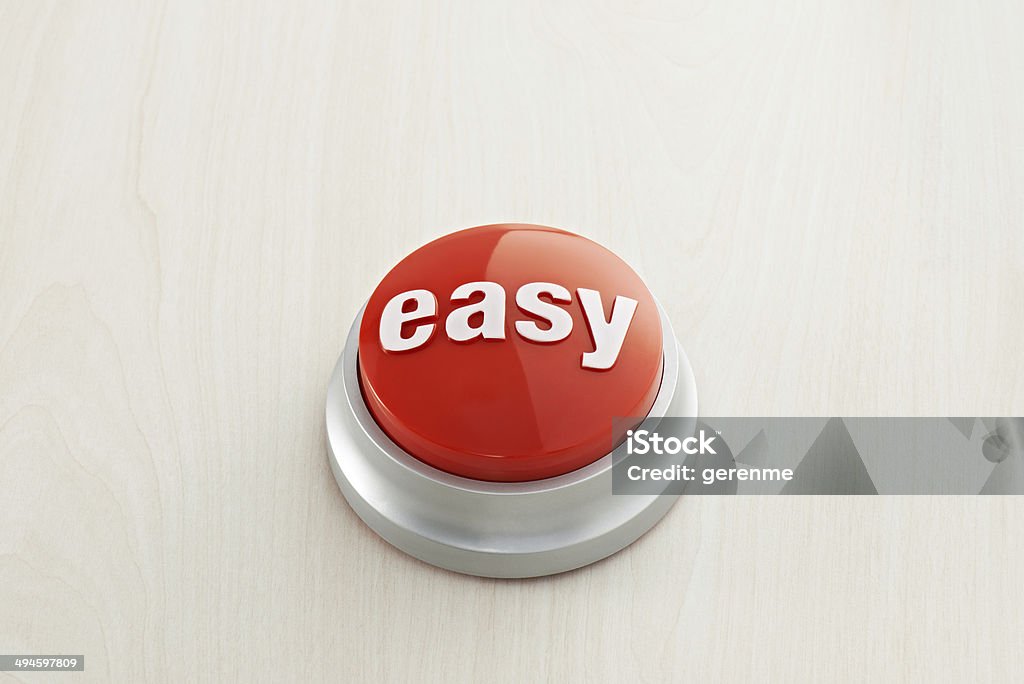 Easy Button Easy button on wood background. Effortless Stock Photo