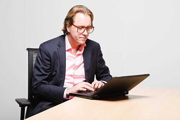 istock Young business man with blond hair working with laptop. 494598813