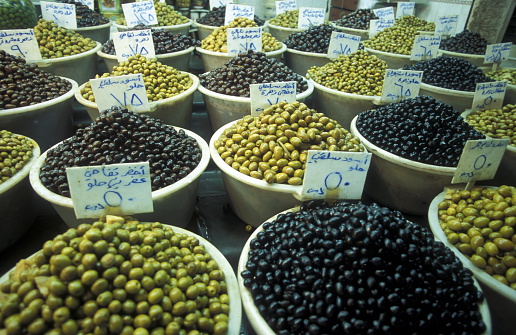 Olives on the souq or market in the medina of the old city of Aleppo in the north of Syria in the Middle East.