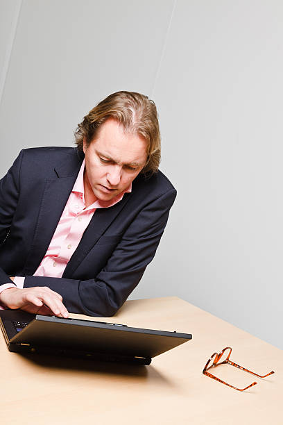 istock Young business man with blond hair working with laptop. 494598905