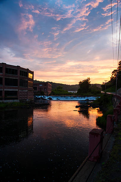 red brick factories black river Springfield Vermont at sunset stock photo