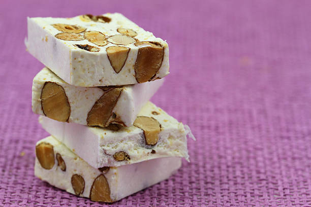 istock Almond nougat on pink background with copy space 494600529