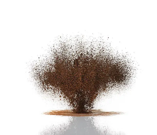 Photo of Brown coffee grinds suspended in the air