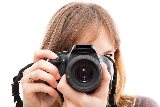 istock young woman using a camera to take photo 494602287