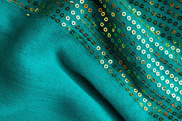 istock Green sequine background texture abstract cloth wavy folds textile 494604067