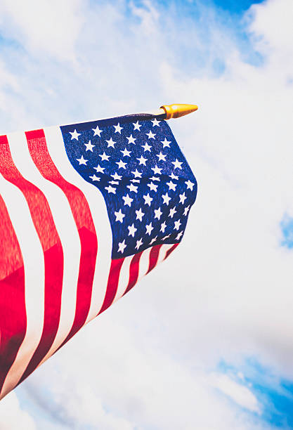 istock Patriotic American flag billowing against summer sky 494604866