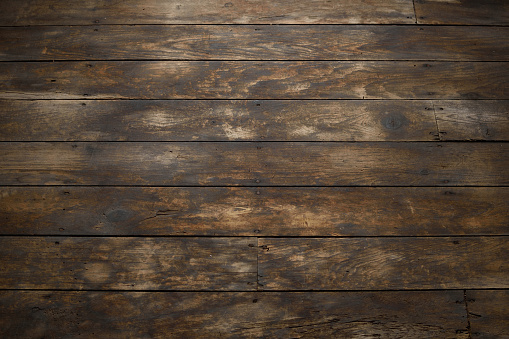 Detail of worn wood plank flooring.