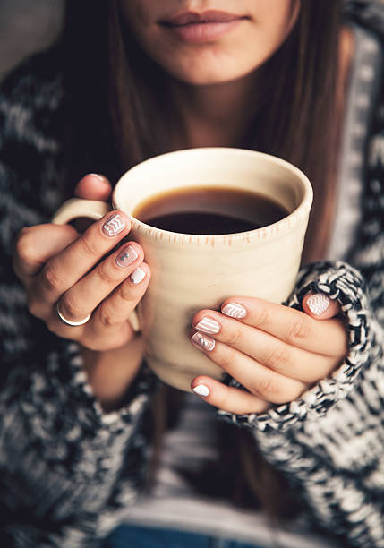 istock cup of coffee in beautiful female hands 494605538