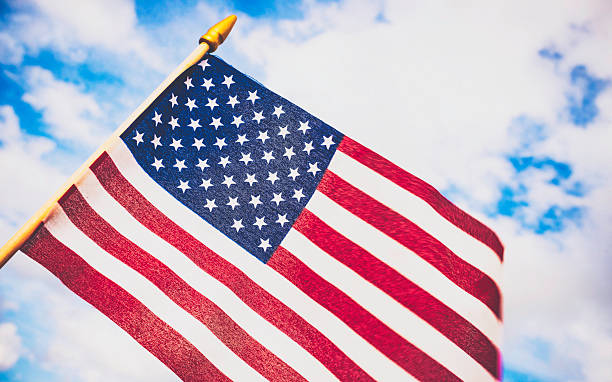 istock Patriotic American flag billowing against summer sky 494607278