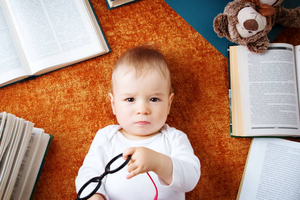 istock One year old baby with spectackles and a teddy bear 494607384