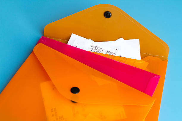 Colorful Filing System: Pink and Orange Plastic Folders with Receipts