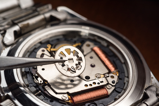 Restoration, repair. Closeup watchmaker's hands repairing mechanical watches isolated over white background. Concept of vintage retro mechanisms, job, work, ad