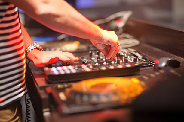 istock DJ mixing music on console at the night club 494610954