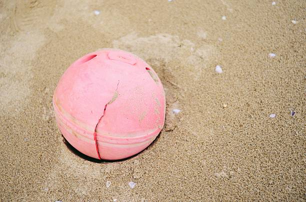 istock Round pink ball on the beach 494613190