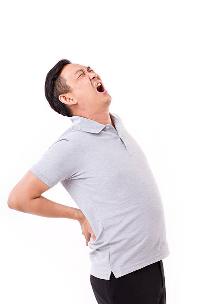 istock man suffering from back pain, hand holding back 494614284