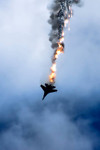 Su-27 performing aerobatics at an airshow Samara, Russia - August 22. 2015: Demonstration performances of flight group "Falcons of Russia" on Su-27. Airshow devoted to the celebration of the National Flag of the Russian Federation stock market crash photos stock pictures, royalty-free photos & images