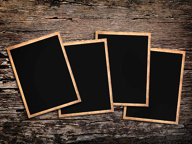 istock old vintage photos on a wooden background 494615112